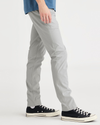Side view of model wearing High-Rise Men's Skinny Fit Smart 360 Flex California Chino Pants.