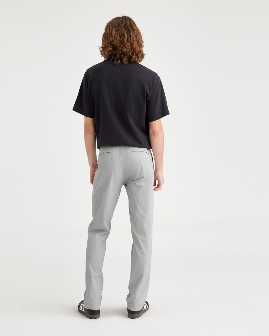 Back view of model wearing High-Rise Men's Slim Fit Smart 360 Flex California Chino Pants.