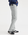 Side view of model wearing High-Rise Men's Slim Fit Smart 360 Flex Jean Cut Pants.