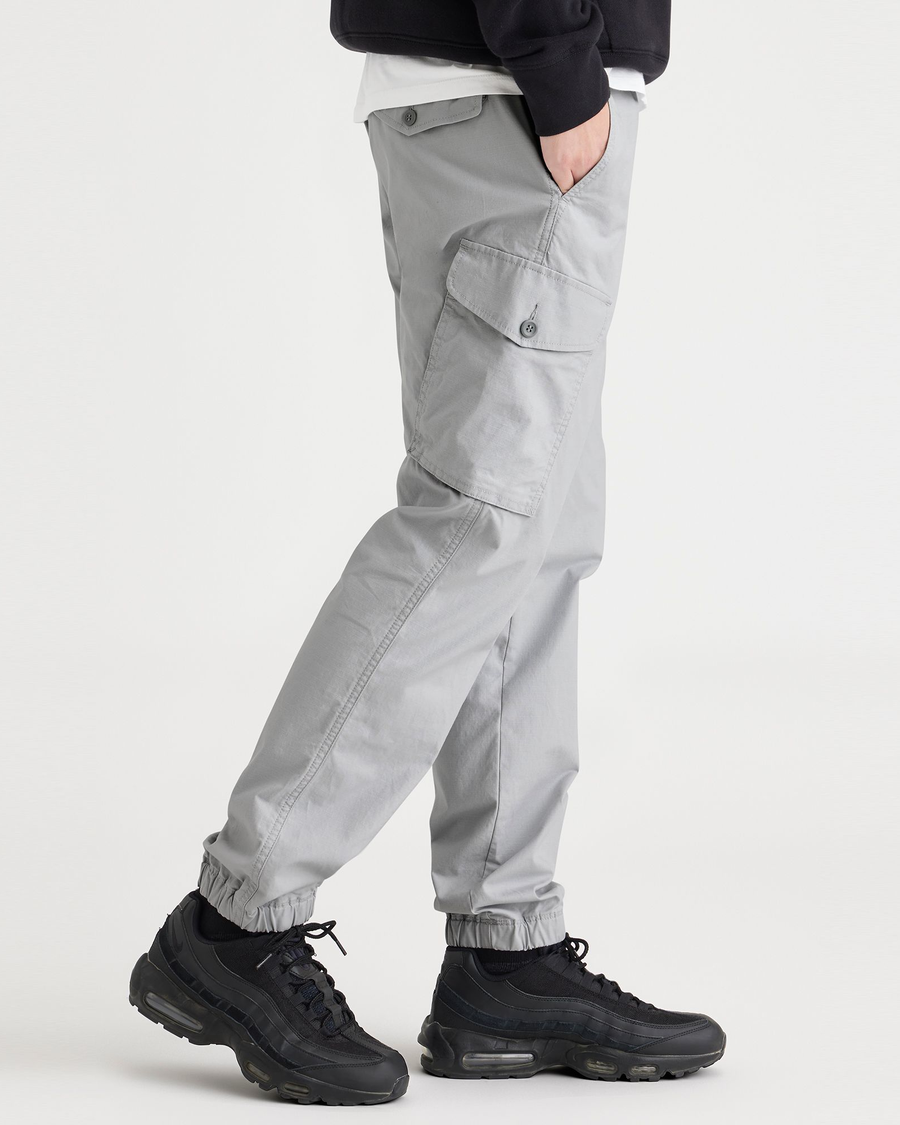 Side view of model wearing High-Rise Men's Straight Tapered Fit Cargo Jogger Pants.