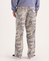 Back view of model wearing Ichabod Buttercream Eighty-Six Utility Pants, Loose Fit.