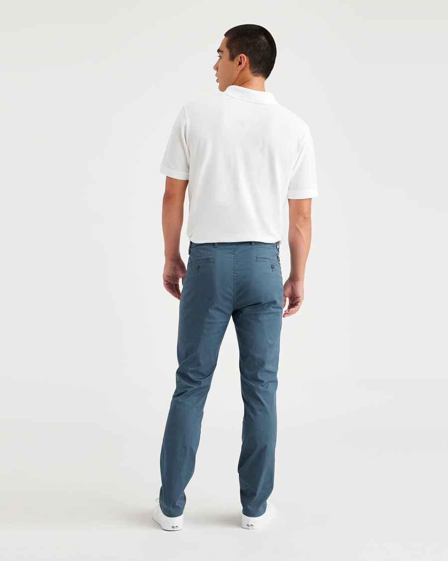 Back view of model wearing Indian Teal Men's Skinny Fit Original Chino Pants.