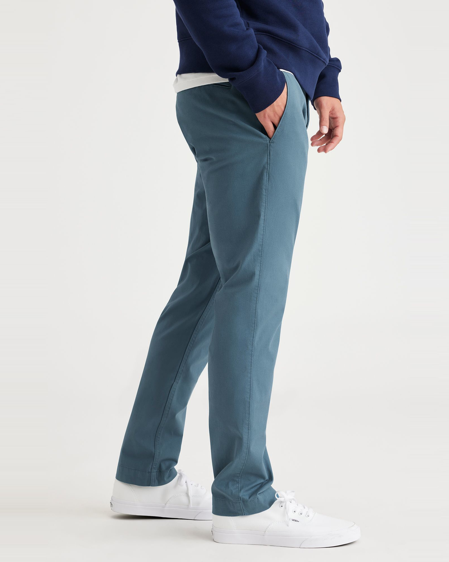 Side view of model wearing Indian Teal Men's Skinny Fit Smart 360 Flex California Chino Pants.