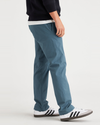 Side view of model wearing Indian Teal Men's Slim Fit Smart 360 Flex California Chino Pants.