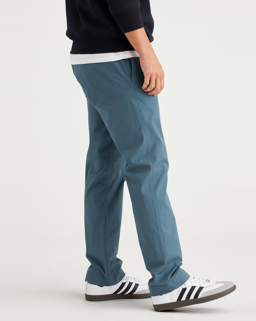 Side view of model wearing Indian Teal Men's Slim Fit Smart 360 Flex California Chino Pants.