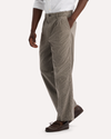 View of model wearing Lemon Pepper Eighty-Six Original Pleated Chinos, Loose Fit.