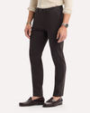 Side view of model wearing Licorice Crafted Khaki Pants, Slim Tapered Fit.
