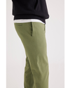 Side view of model wearing Loden Green Alpha Chino Pants, Skinny Fit.