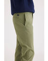 Side view of model wearing Loden Green Alpha Chino Pants, Slim Fit.