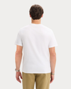 Back view of model wearing Lucent White Graphic Tee, Regular Fit.