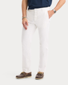 Side view of model wearing Lucent White Original Chino Pants, Slim Fit.