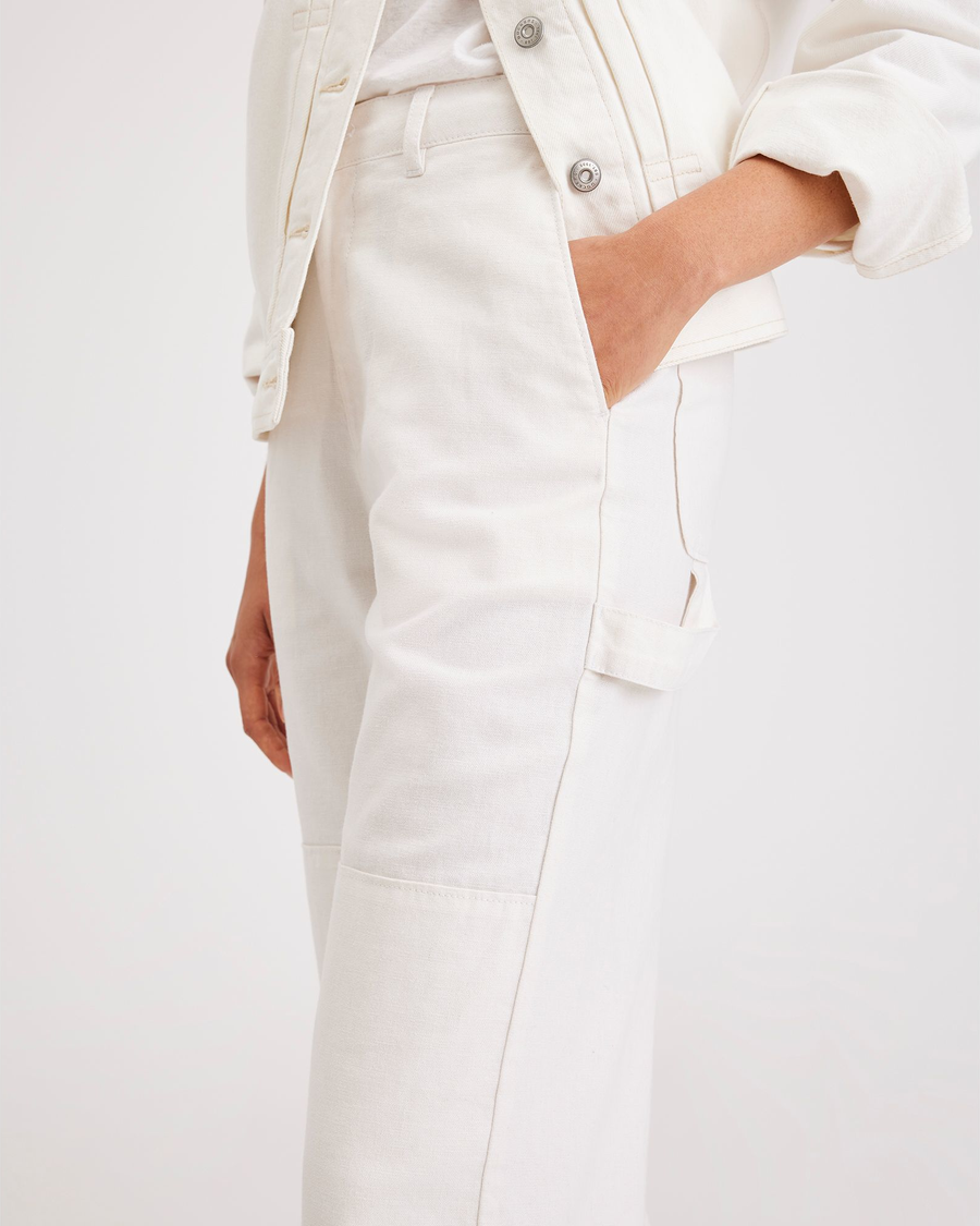 View of model wearing Lucent White Women's Straight Fit Carpenter Pants.