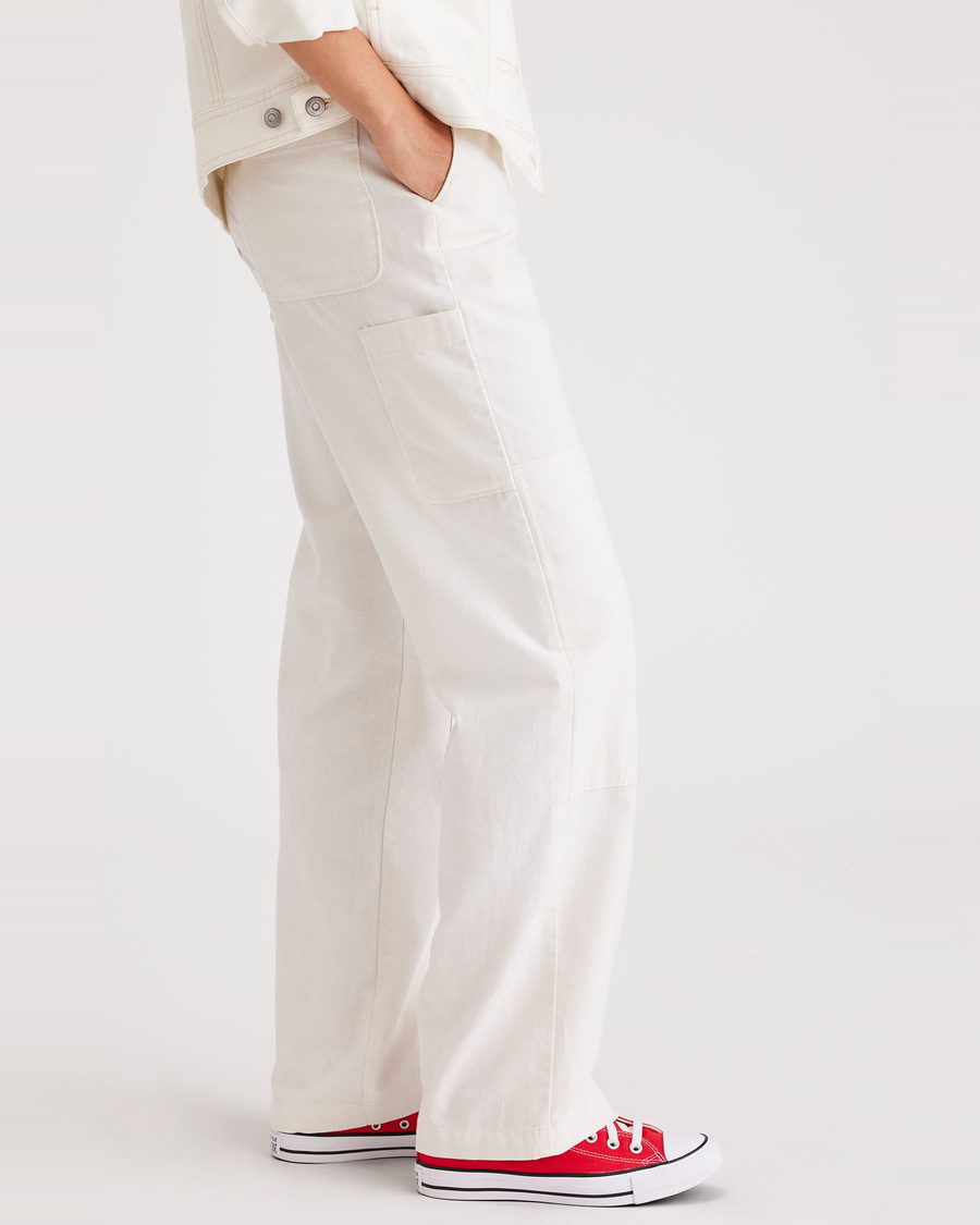 Side view of model wearing Lucent White Women's Straight Fit Carpenter Pants.