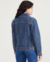 Back view of model wearing Medium Indigo Stonewash Women's Regular Fit Original Trucker Jacket.
