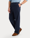 Side view of model wearing Navy Blazer Eighty-Six Original Chino Pants, Loose Fit.