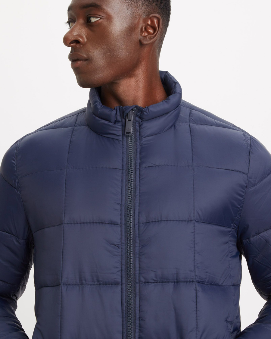 View of model wearing Navy Blazer Men's Nylon Lightweight Quilted Jacket.