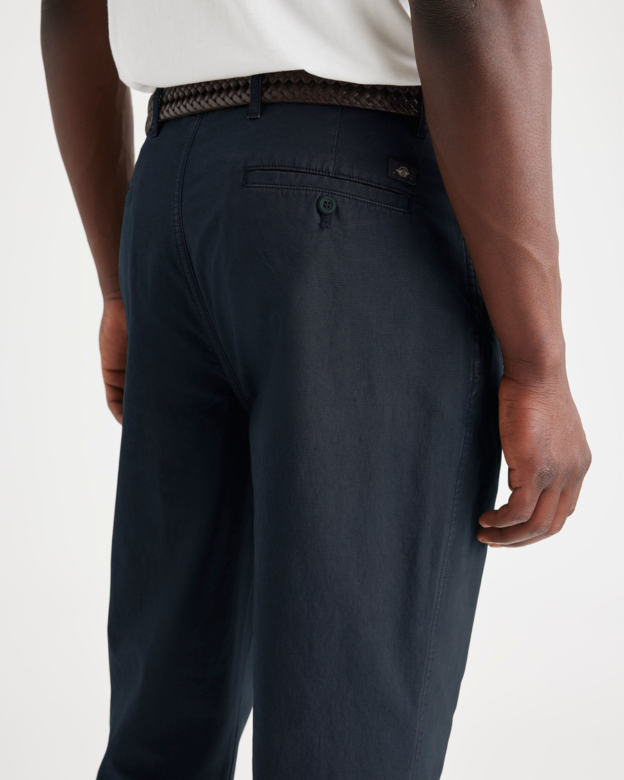 View of model wearing Navy Blazer Men's Relaxed Taper Fit Original Pleated Chino Pants.