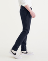 Side view of model wearing Navy Blazer Men's Skinny Fit Smart 360 Flex California Chino Pants.