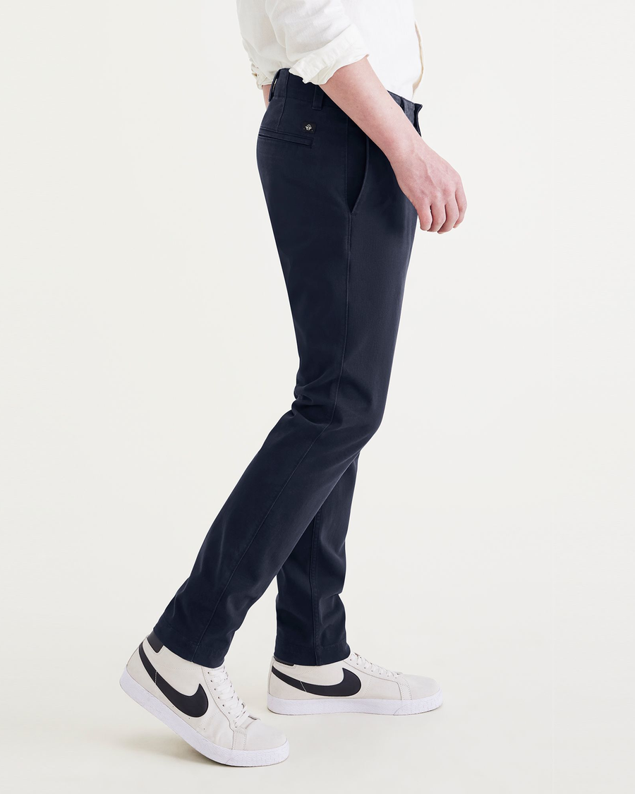Side view of model wearing Navy Blazer Men's Skinny Fit Smart 360 Flex California Chino Pants.