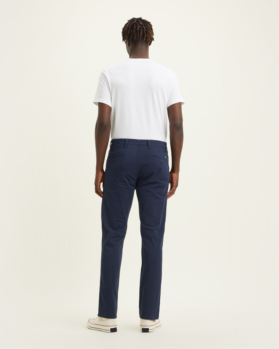 Back view of model wearing Navy Blazer Men's Slim Fit Supreme Flex Alpha Khaki Pants.