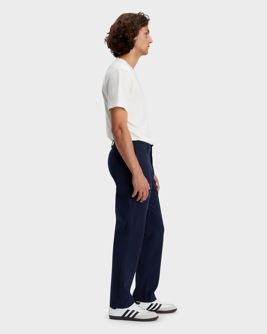 Side view of model wearing Navy Blazer Men's Straight Fit Smart 360 Flex California Chino Pants.