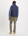 Back view of model wearing Navy Blazer Quilted Vest, Regular Fit.