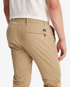 View of model wearing New British Khaki Men's Skinny Fit Smart 360 Flex Alpha Khaki Pants.