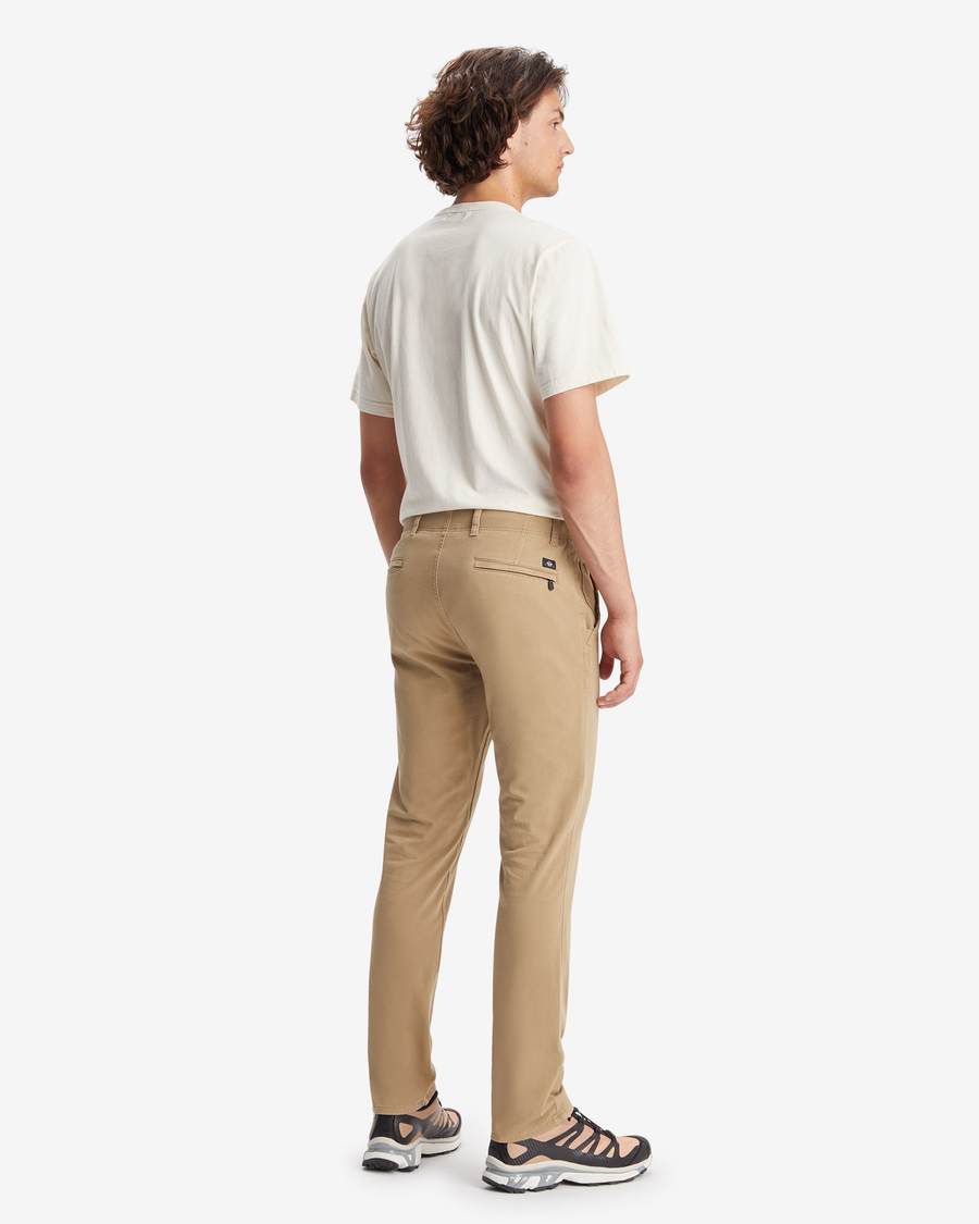 Back view of model wearing New British Khaki Men's Skinny Fit Smart 360 Flex Alpha Khaki Pants.