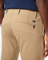 View of model wearing New British Khaki Men's Slim Fit Smart 360 Flex Alpha Khaki Pants.