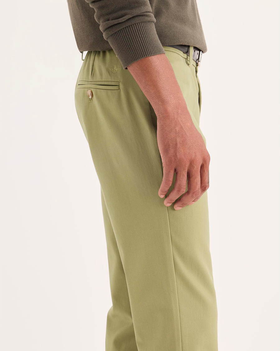 Side view of model wearing New British Khaki Signature Iron Free Khakis, Skinny Fit with Stain Defender®.