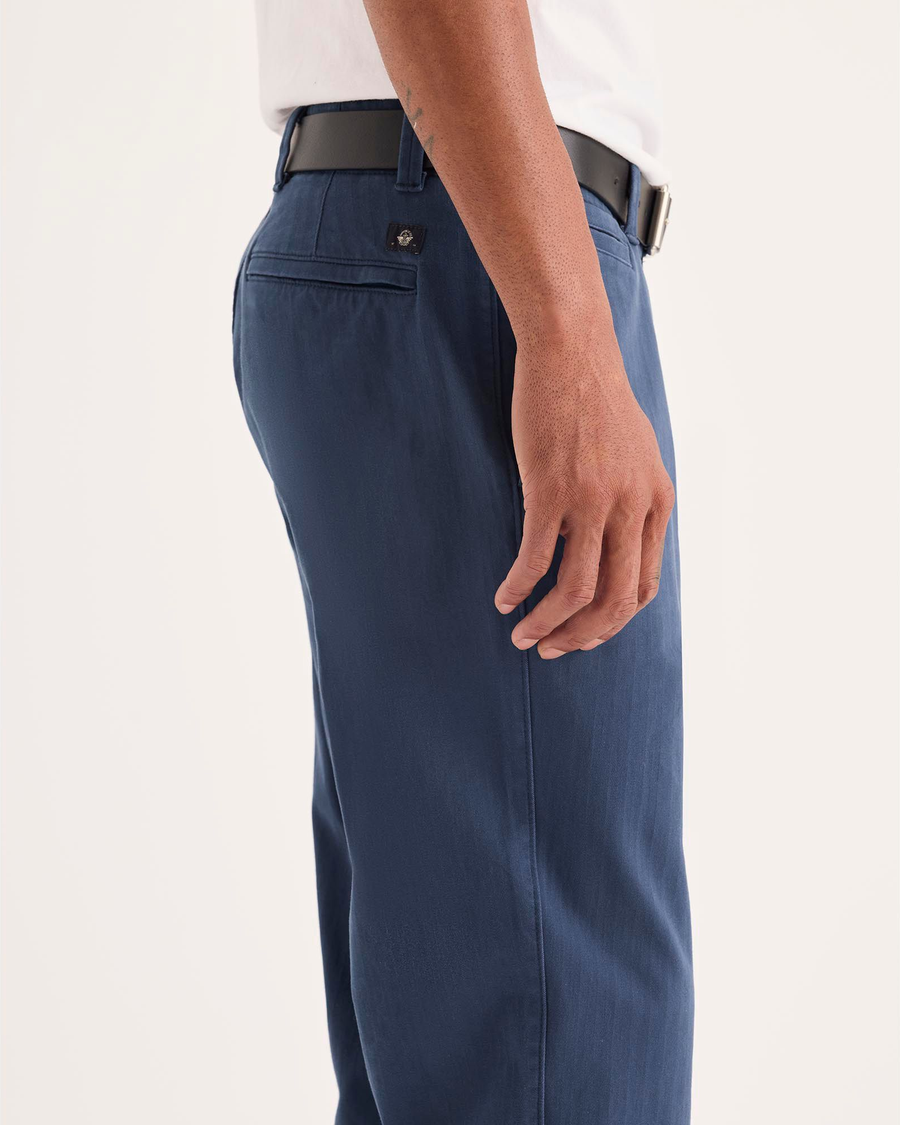 Side view of model wearing Ocean Blue Alpha Chino Pants, Slim Fit.