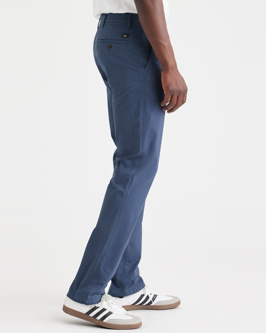 Side view of model wearing Ocean Blue Men's Slim Fit Original Chino Pants.