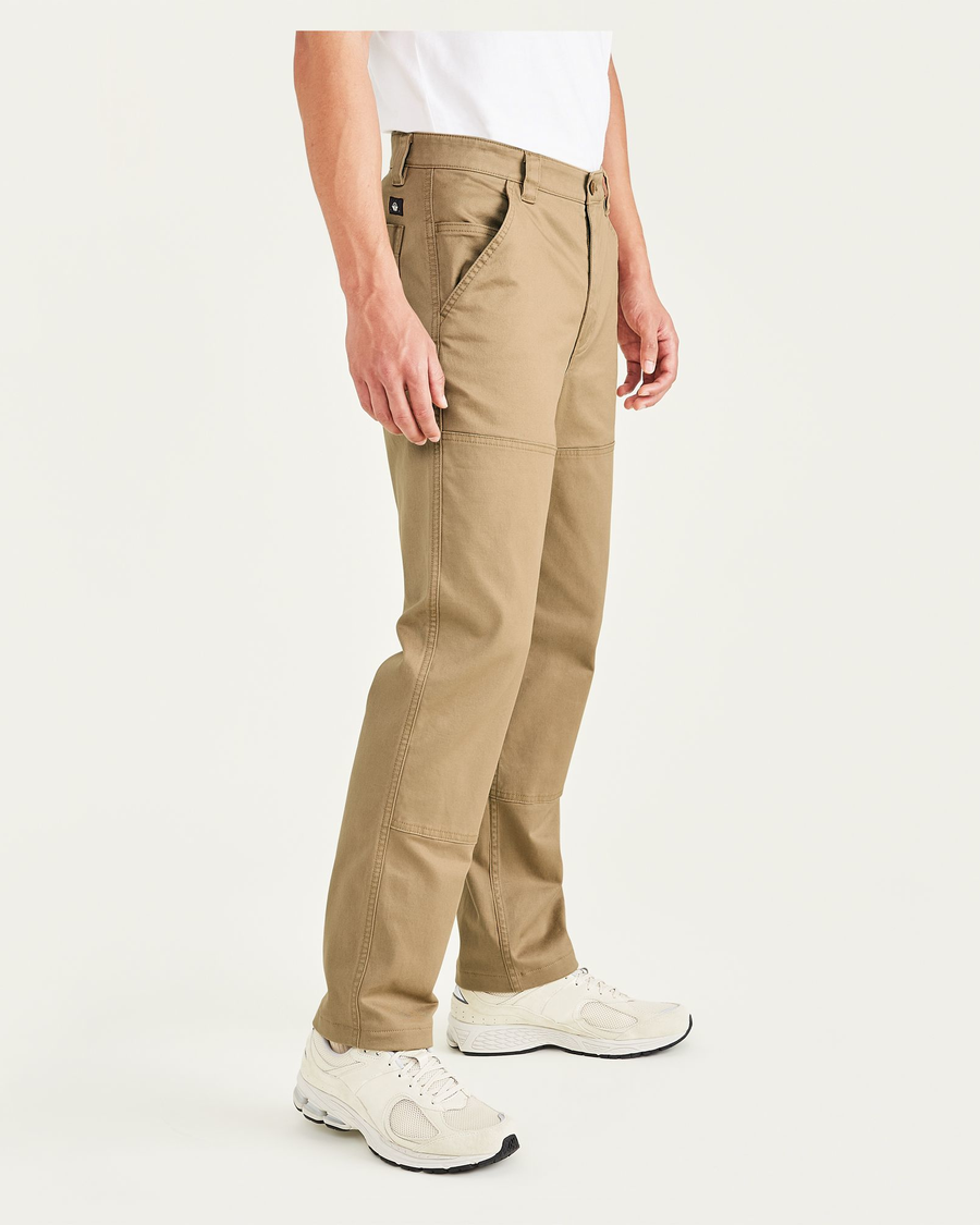 Side view of model wearing Otter Men's Straight Fit Utility Pants.