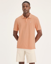 Front view of model wearing Peach Bloom Men's Slim Fit Pique Polo.