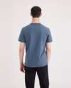 Back view of model wearing Placid Blue Men's Slim Fit Logo Tee.