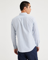 Back view of model wearing Ripple Powder Blue Men's Slim Fit Icon Button Up Shirt.
