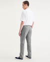 Back view of model wearing Sharkskin Men's Slim Fit Smart 360 Flex California Chino Pants.