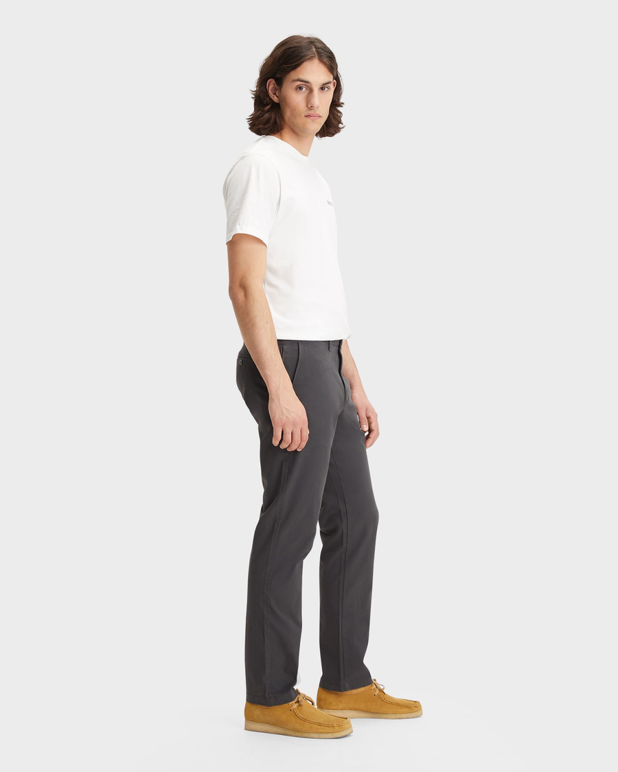 Side view of model wearing Steelhead Crafted Khaki Pants, Slim Fit.