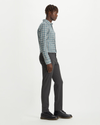 Side view of model wearing Steelhead Crafted Khaki Pants, Slim Tapered Fit.