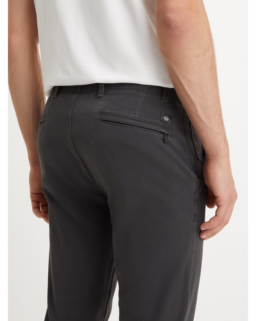 View of model wearing Steelhead Men's Skinny Fit Smart 360 Flex Alpha Khaki Pants.