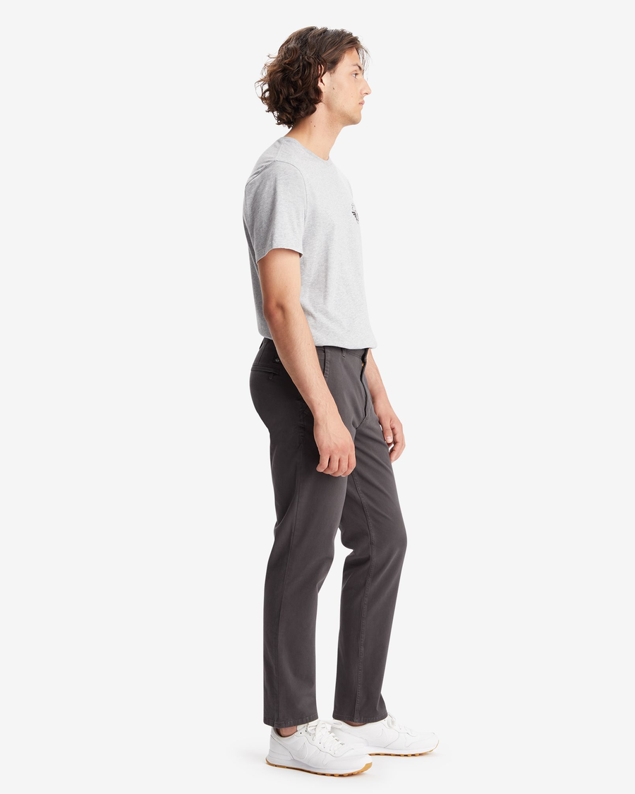 Side view of model wearing Steelhead Men's Slim Fit Smart 360 Flex Alpha Khaki Pants.