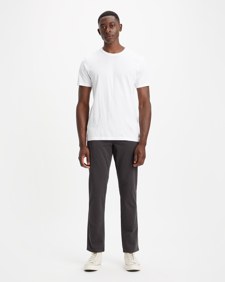 View of model wearing Steelhead Men's Slim Fit Supreme Flex Alpha Khaki Pants.