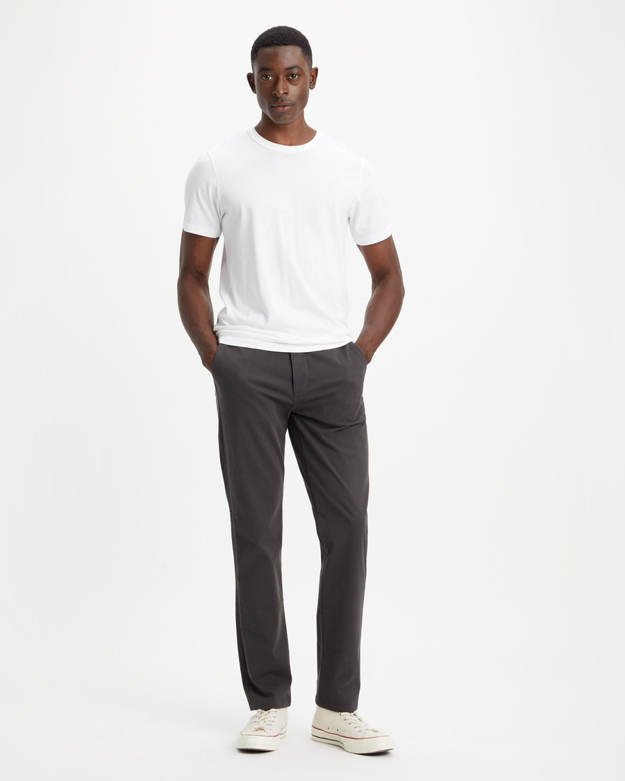 Front view of model wearing Steelhead Men's Slim Fit Supreme Flex Alpha Khaki Pants.