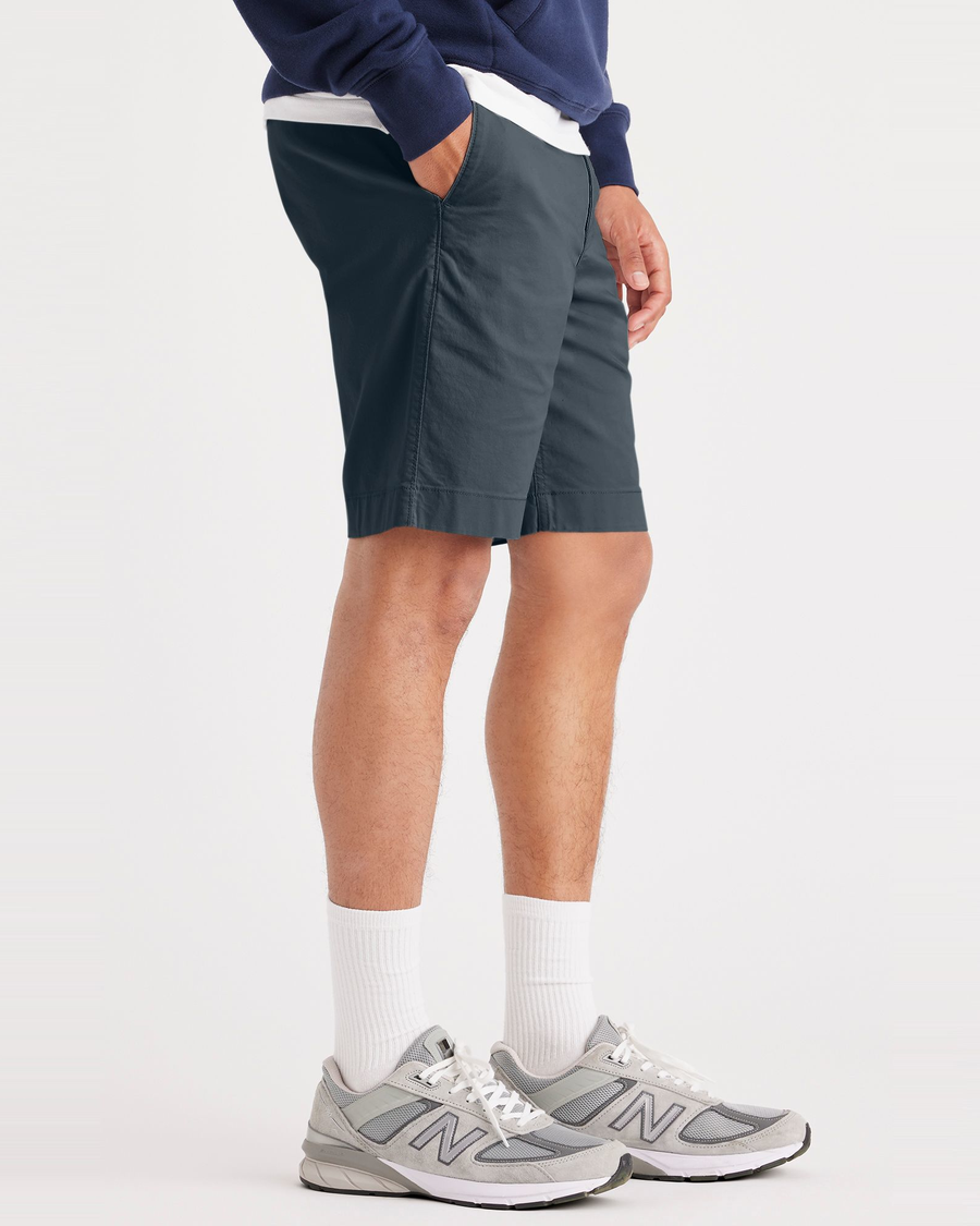 Side view of model wearing Stratified Sea Alpha Chino Shorts, Straight Fit.