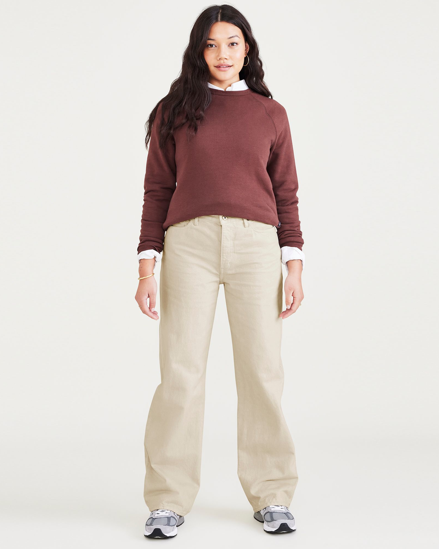 Front view of model wearing Tan Garment Dye Women's Relaxed Fit Mid-Rise Jeans.
