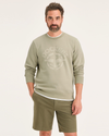 Front view of model wearing Traveler Tidal Foam (Buttercream) Men's  Regular Fit Crewneck Sweatshirt.