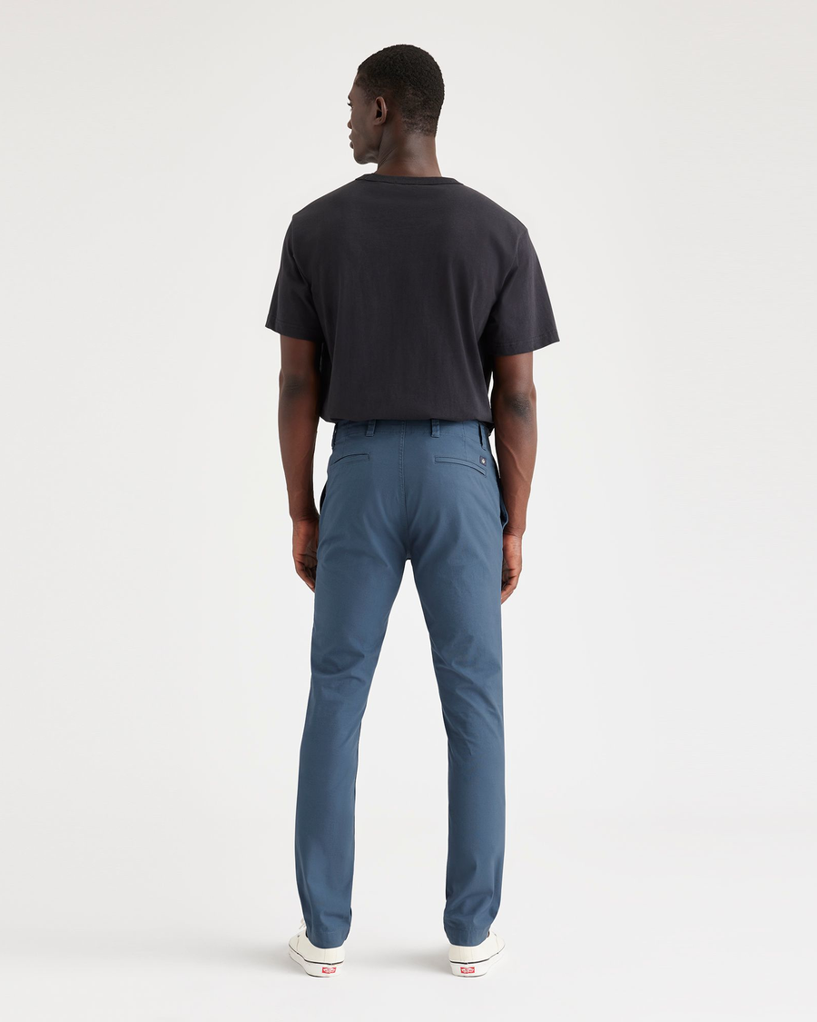 Back view of model wearing Vintage Indigo Men's Skinny Fit Smart 360 Flex California Chino Pants.